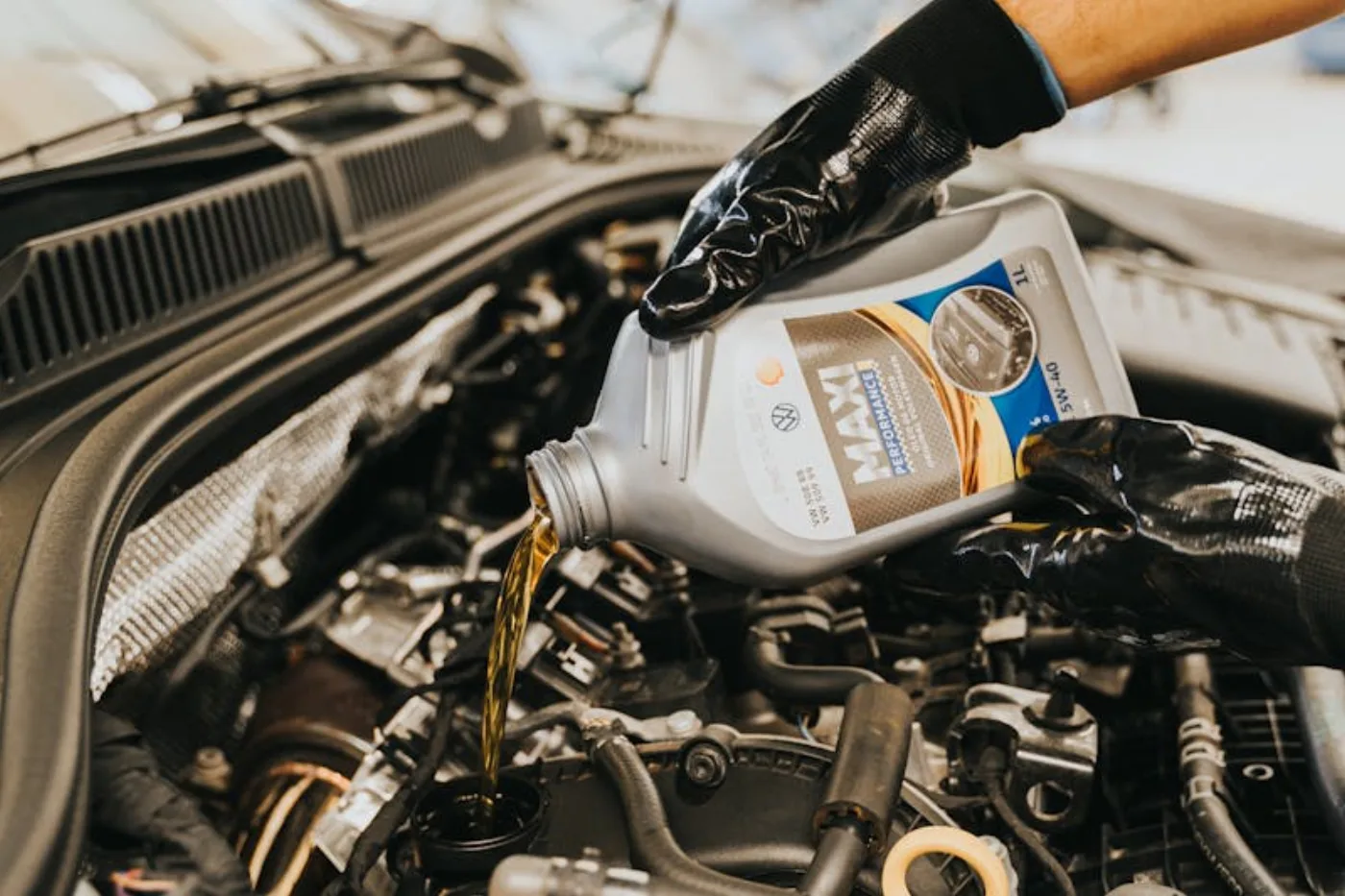 Fresh motor oil being poured into an engine